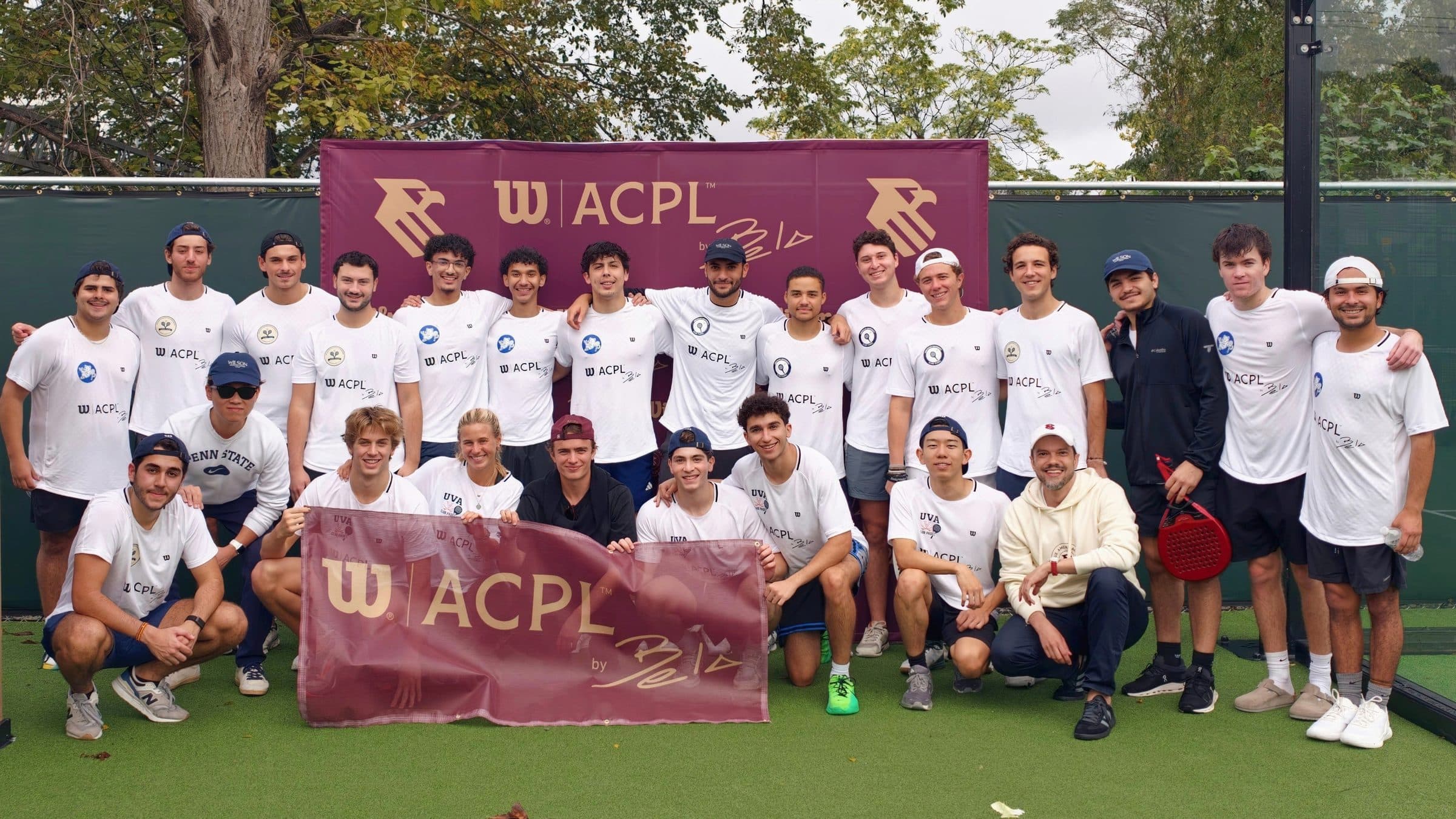 Players at the DC City Invitational holding the Wilson ACPL by Bela banner